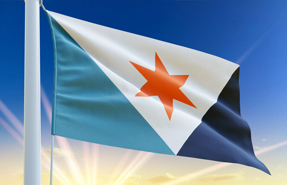 Syracuse city flag waving on a flagpole against a blue sky