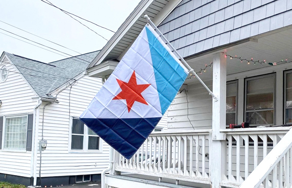 The Syracuse city flag mounted on a home's front porch.